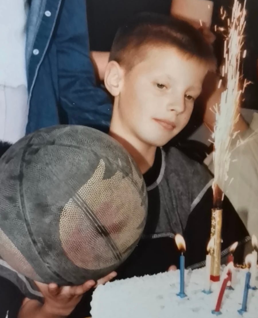Young Stefan Stankovic holding a basketball