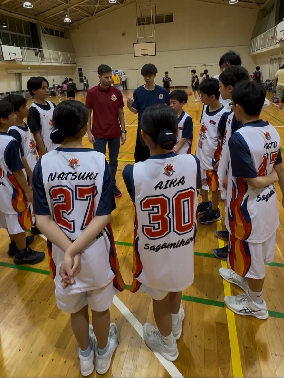Coach Stefan Stankovic in a team huddle with players