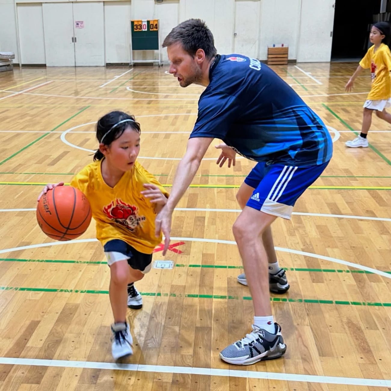 Coach Stefan Stankovic in a 1-on-1 defensive drill with a young player