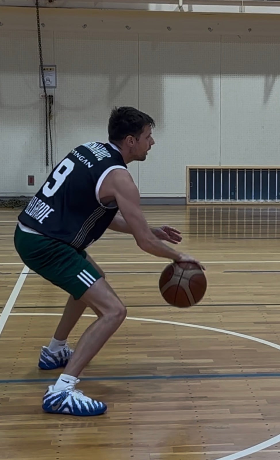 Coach Stefan Stankovic in a defensive dribbling stance during training