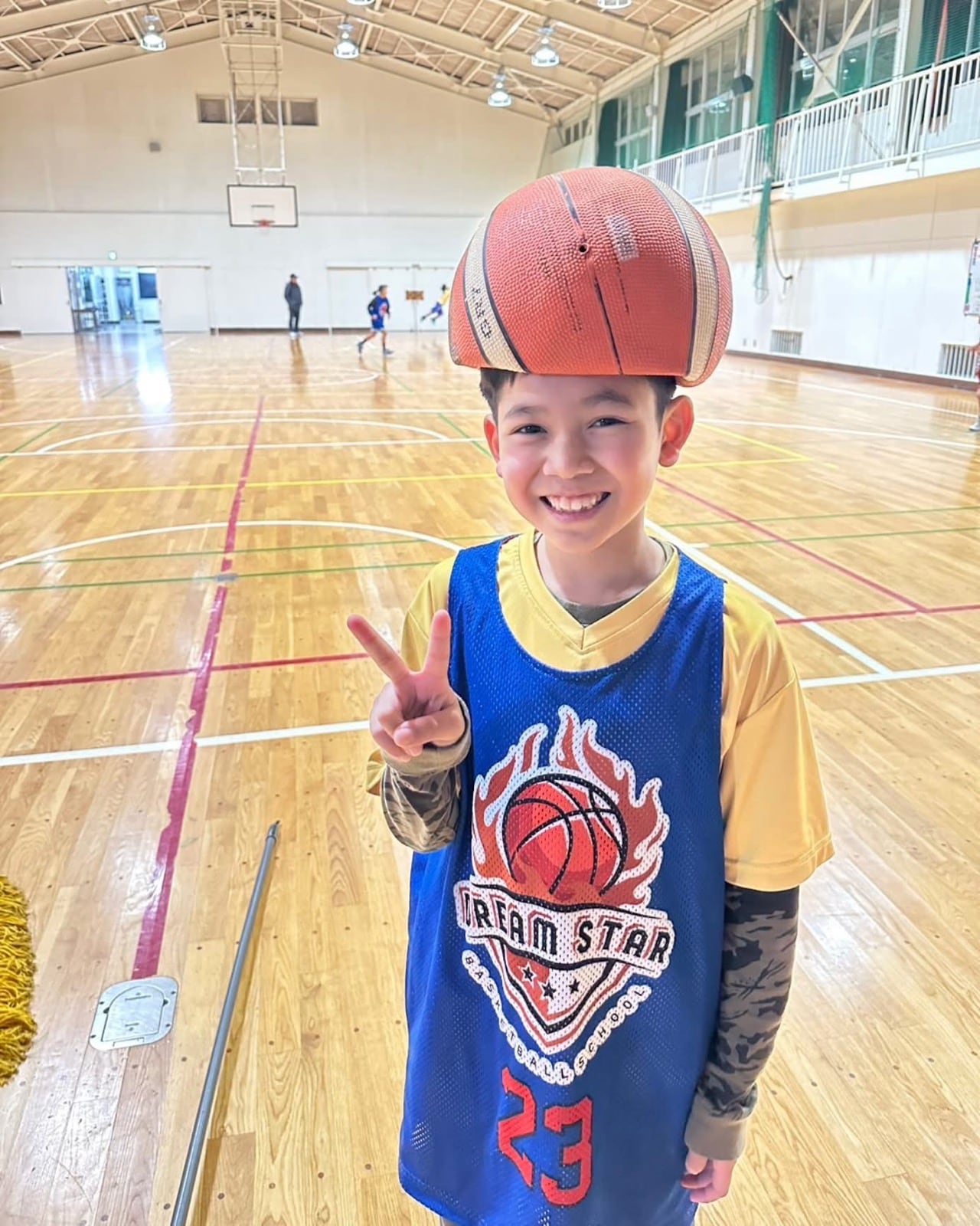 Young player balancing a basketball on his head