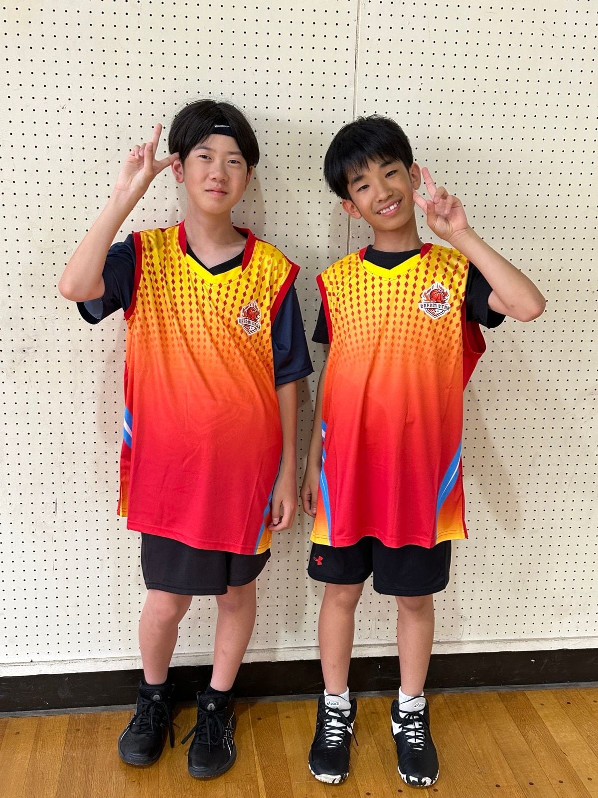 Two Dream Star players posing in team jerseys